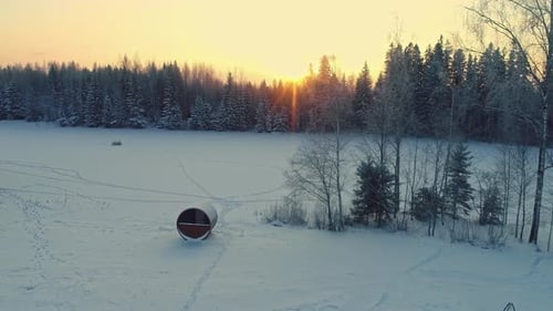 Winter Landscape with Sauna and Cabin at Sunrise