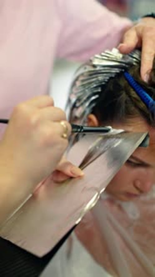 Woman Getting Hair Dyed Blonde at Salon