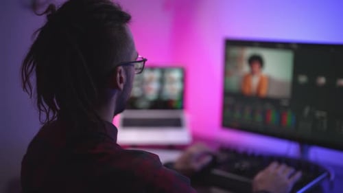 Video Editor Working Late at Computer