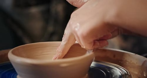 Hands Shaping Clay on Pottery Wheel