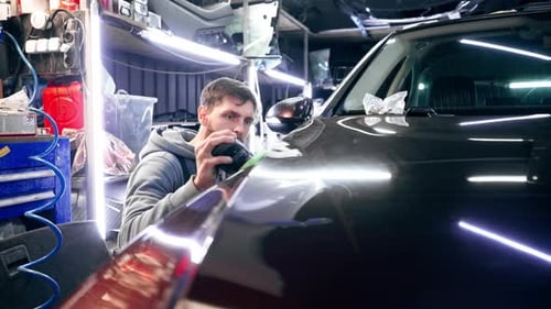 the Car Mechanic at a Service Station Doing the Final Polishing to Shine