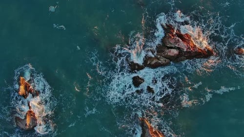 Top View of Waves and Rocks in Sea