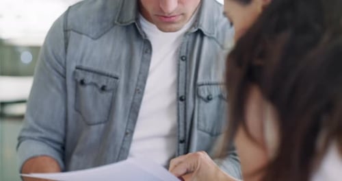 Couple Reviewing Paperwork Together in Bright Home