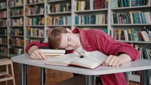 Freshman Student Falls Asleep Learning Material for Exams