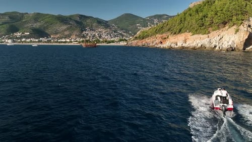 Aerial Drone Tracking Top Down Video of Yacht Cruising in Deep Blue Open Ocean Sea