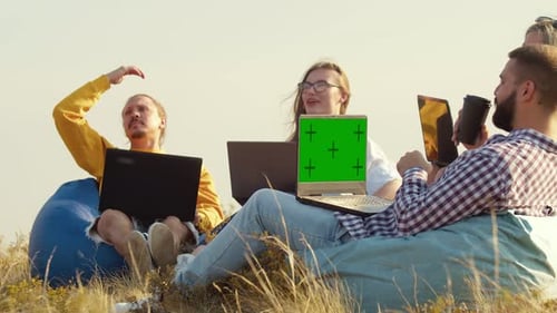 Group of Freelancers are Sitting in Circle Talking Each Other on Hill Sitting in Chairs Bag Laptops