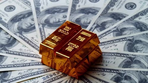 Gold Bar On Background Of US One Hundred Dollar Bills Investment Concept