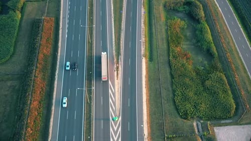 Aerial top view of highway road. Drone view of the elevated road, traffic junctions, and green garde