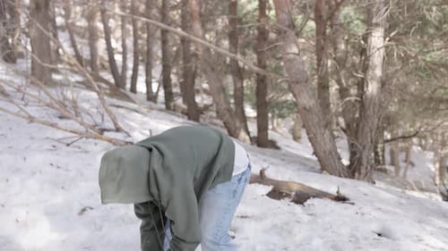 Playful Snowball Fight in Forested Winter Wonderland
