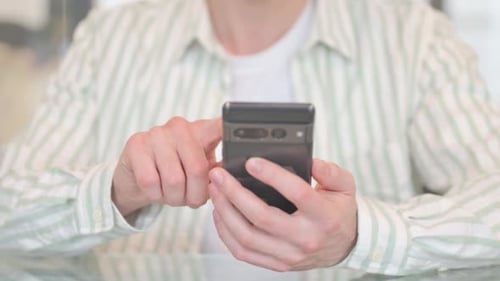Close up of Hand Browsing Internet on Phone