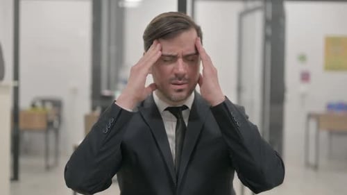Man with Headache in Office Setting
