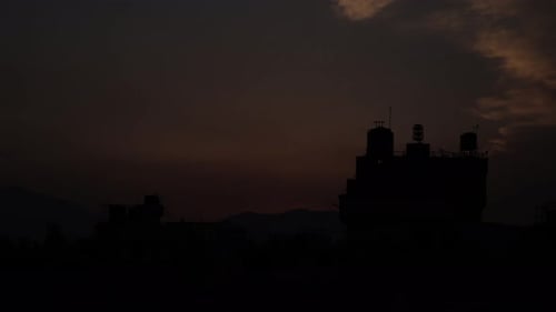 Sunrise in the mountains Timelapse. Orange Sun Rising from behind the mountain.