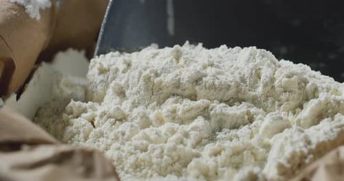 Scoop Fills and Pours Flour into Brown Bag