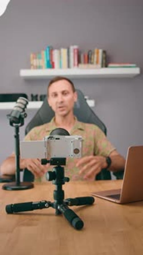 Man Recording Video Blog on Camera at Desk