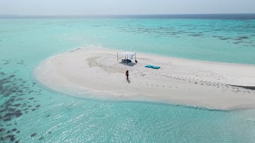 Aerial View of a Private Island in the Maldives Featuring Turquoise Waters and White Sand Beaches