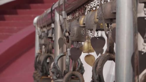 Bells Swinging in the Wind at Buddhist Temple. Near Focus. Slow Motion.