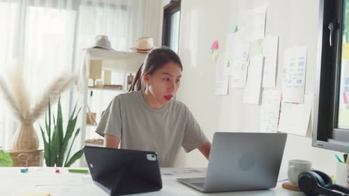 Asia girl IT development programmer typing on keyboard coding programming fixing data code on laptop