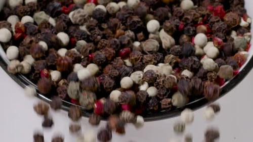Colorful Peppercorns Flowing Down in Slow Motion