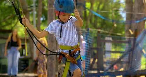 Child Navigating Ropes Course in Adventure Park
