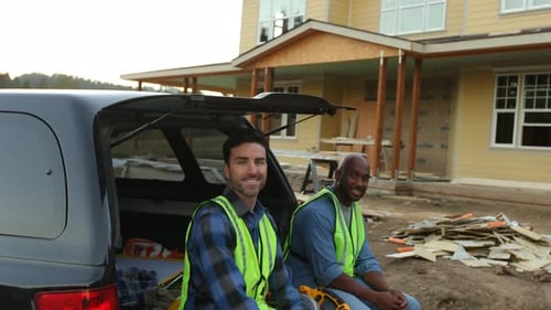Construction Workers Sitting in Truck at Construction Site