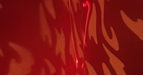 Abstract Red Light Moving Across Textured Background