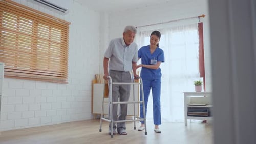 Caregiver Assisting Senior Man Walking with Walker