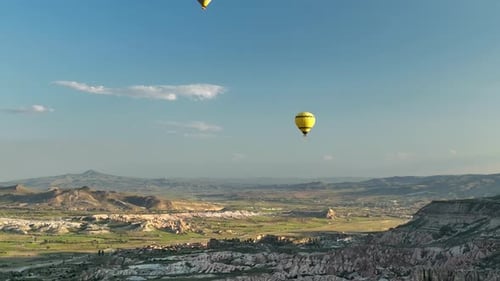 Hot Air Balloons Fly Over the Mountainous Landscape of Cappadocia Turkey