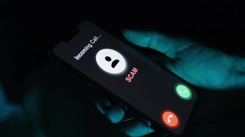 Cell Phone Scam Alert on Screen at Night