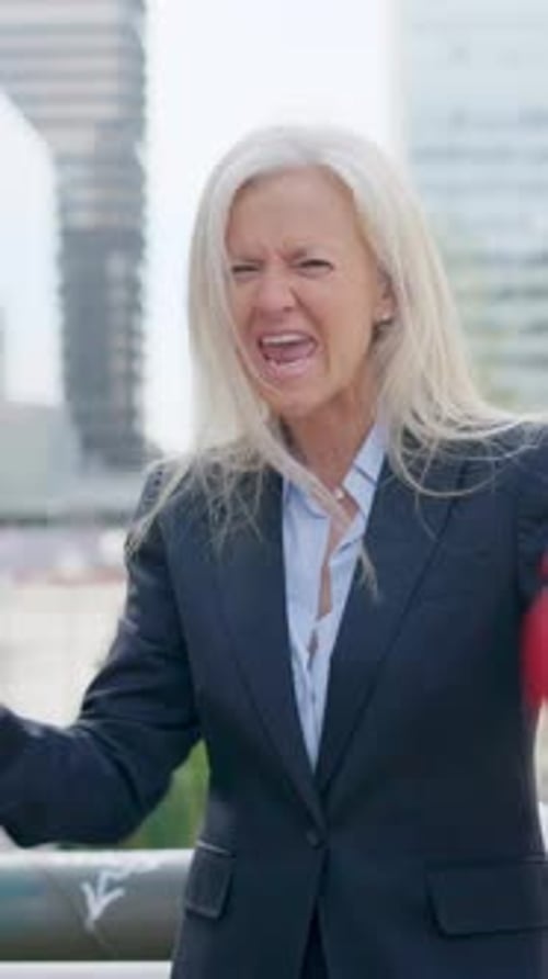 Mature Aggressive Businesswoman Screaming Clashing Boxing Gloves Outdoors