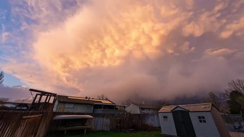 Large storm clouds moving over houses during sunset in Utah