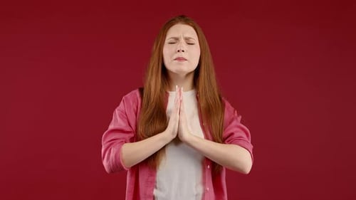 Young Adult Woman Praying with Worried Expression