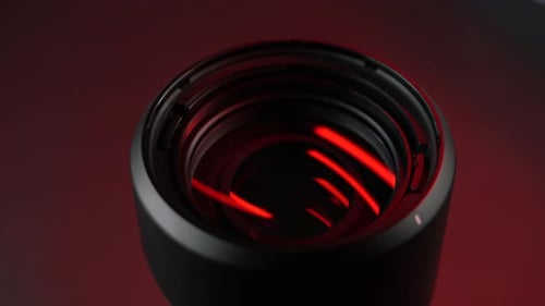 Sleek Black Object Illuminated with Pulsating Red Light