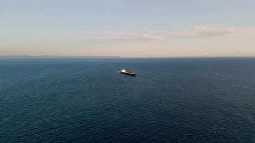 Barge carrier sailing calm deep ocean waters drone view at clear sky day