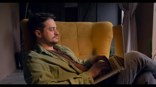 Man Working on Laptop in Comfortable Chair