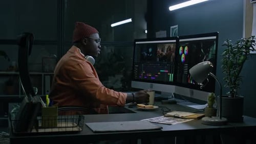 Man Works at Computer in a Modern Office