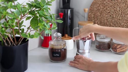 Woman Assembling Moka Pot in Bright Kitchen