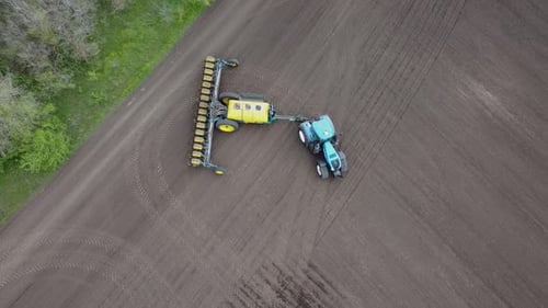 Blue tractor OA working on the field in Ukraine