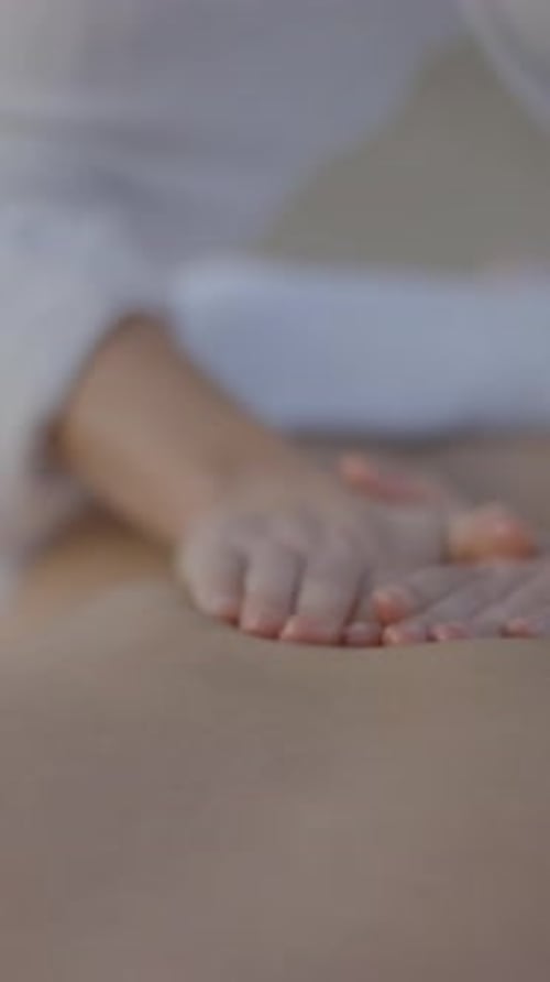 Unknown Masseuse Performing Massage at the Beach Focus on Hands