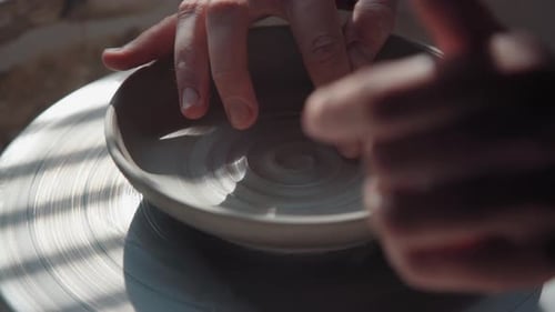 Hands Shaping Clay Bowl on Pottery Wheel