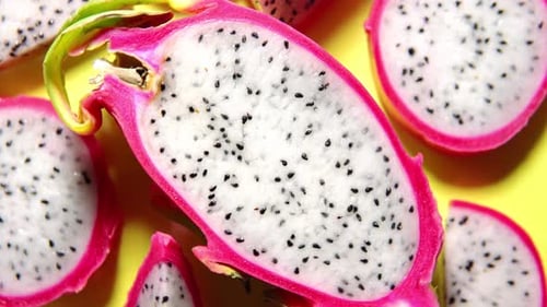 Dragon Fruit Slices on a Yellow Background