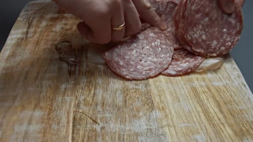 Fresh Italian Sliced Salami Sausage on a Wooden Cutting Board Cutting Heart Shapes of Milano Salami