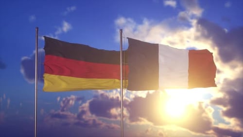 Germany and France Flags Waving in Blue Sky