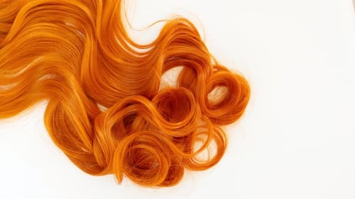 Vibrant Orange Wavy and Curly Hair Close-Up