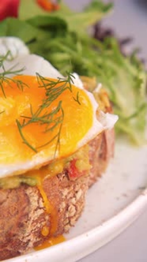 Delicious Brunch Dish Featuring Poached Egg and Fresh Salad Served in a Cozy Cafe