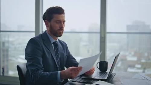 Busy Accountant Working Laptop Sitting Office Looking Documents at Desk Closeup