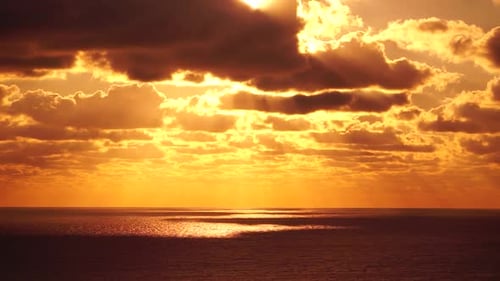 Timelapse Dramatic Sunset with Fluffy Clouds Moving in Golden Burning Sky Over Sea Abstract Aerial