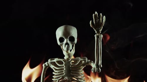 Close Up Skeleton Waving with Fire Backdrop
