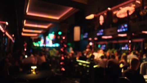 The Vibrant Nightlife Scene in a Contemporary Bar Showcases Patrons Energetically Socializing with
