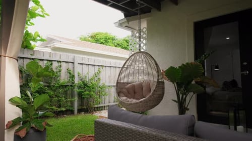 Cream Colored Hanging Chairs in the Tropical Garden Move Camera Footage