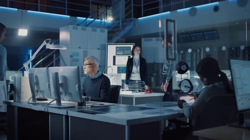 Engineers Collaborating on Tech Project in Modern Office